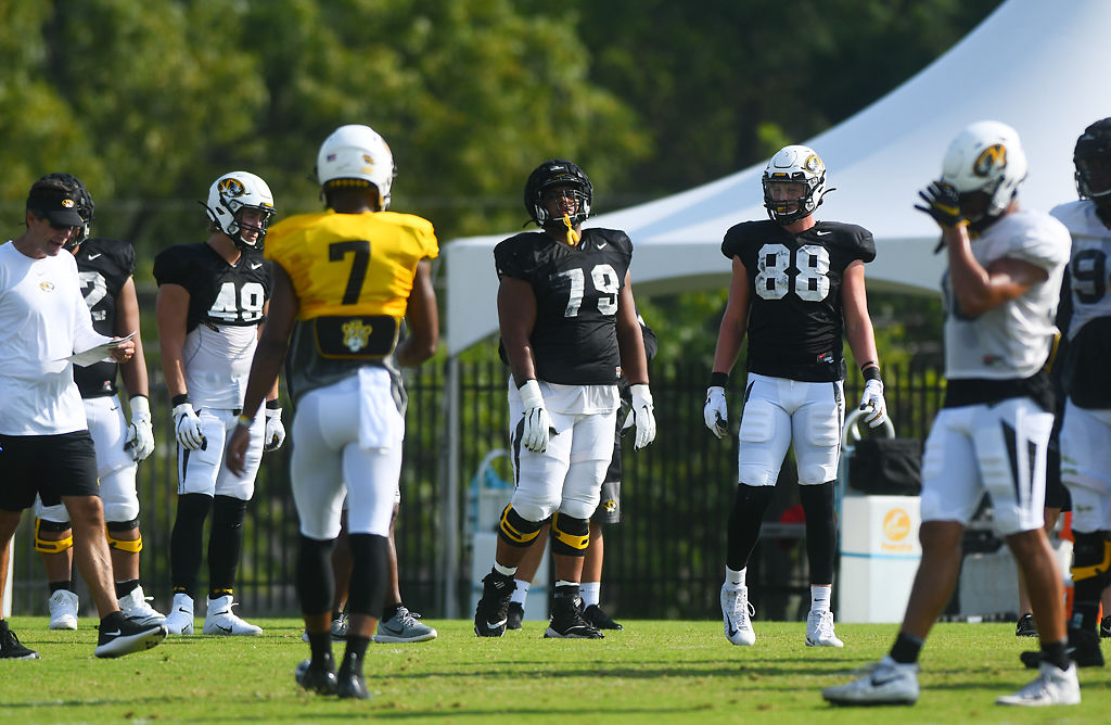 Jake Hoffman, Larry Borom and Logan Christopherson watch their teammates run drills